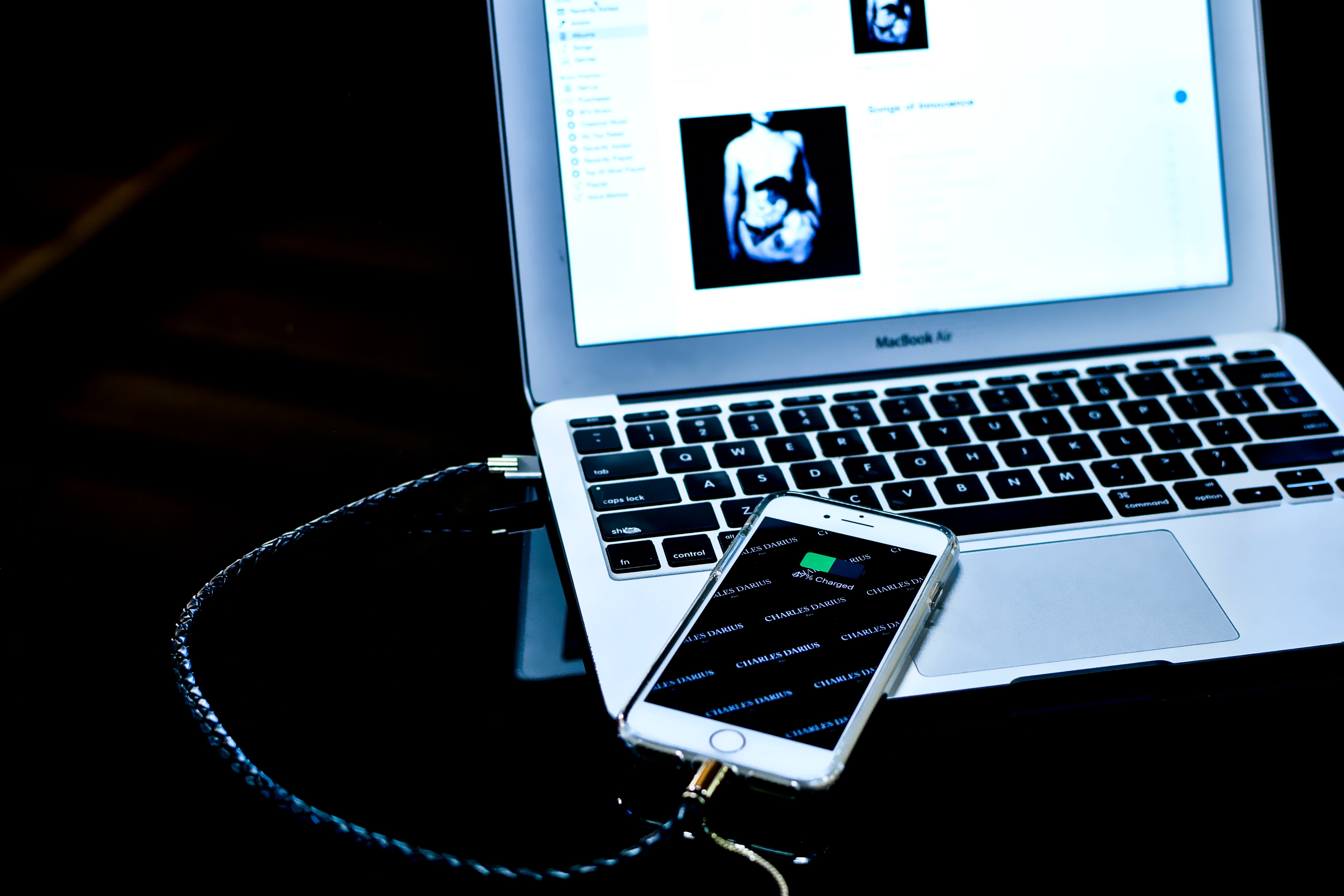 Photography of charles darius bolt bracelet charging and synchronizing iPhone to MacBook Air